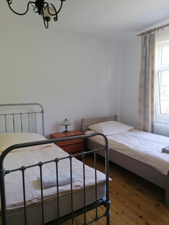 Postel nebo postele na pokoji v ubytování Zielony Zakątek