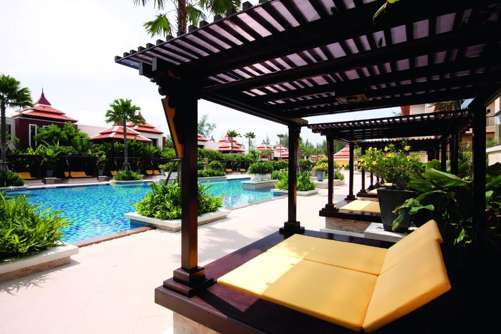 a pergola next to a pool at a resort at Mövenpick Resort Bangtao Beach Phuket in Bang Tao Beach
