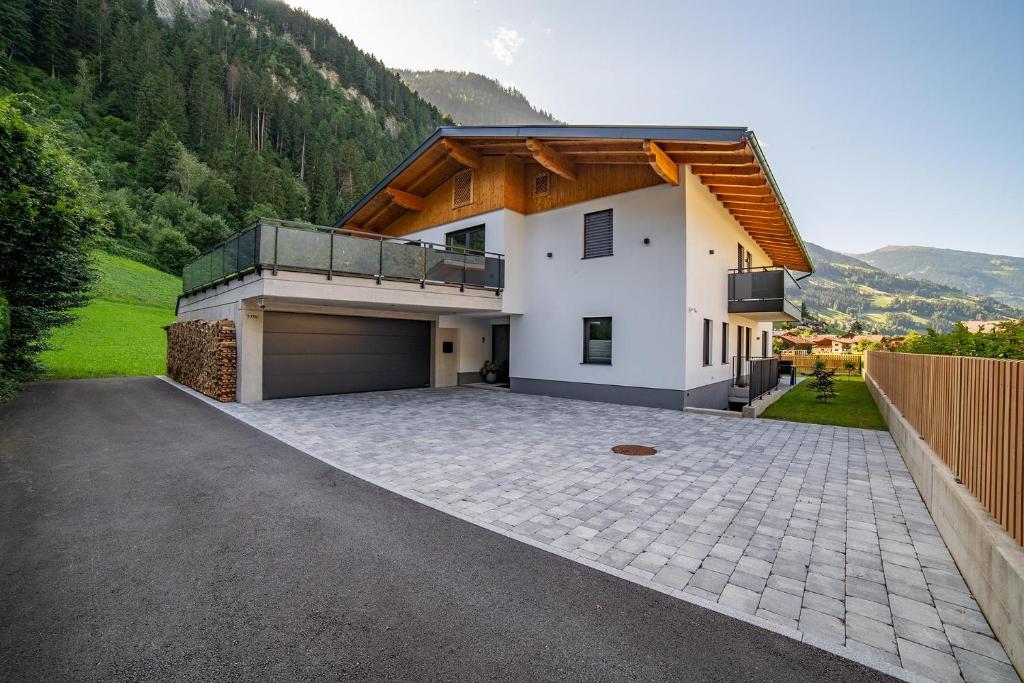 a house with a parking lot with a garage at Apartment Hoflacher in Schwendau