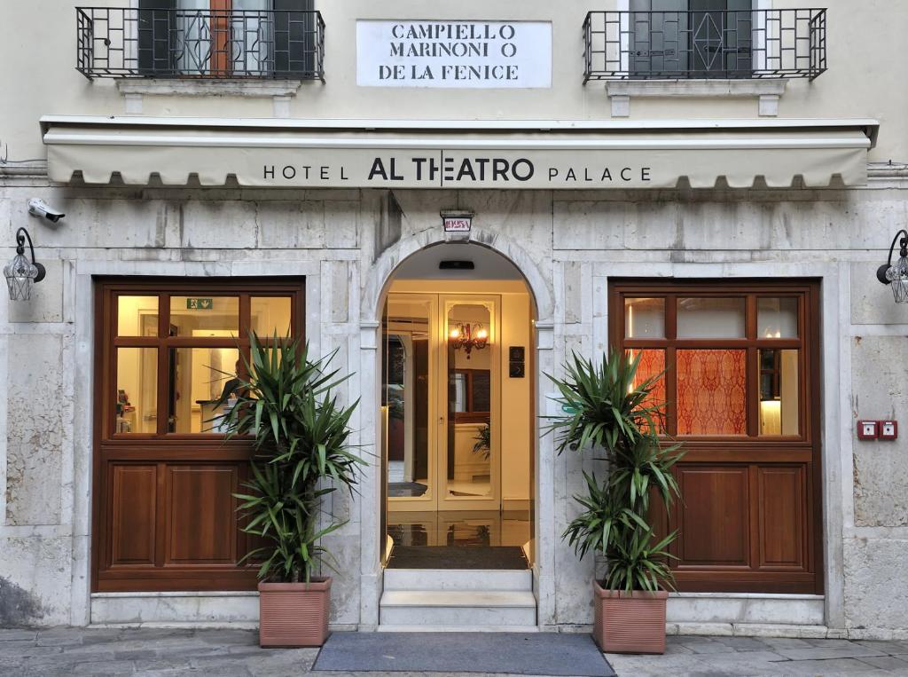 a hotelalloallo palace entrance with two doors and two plants at Al Theatro Palace in Venice