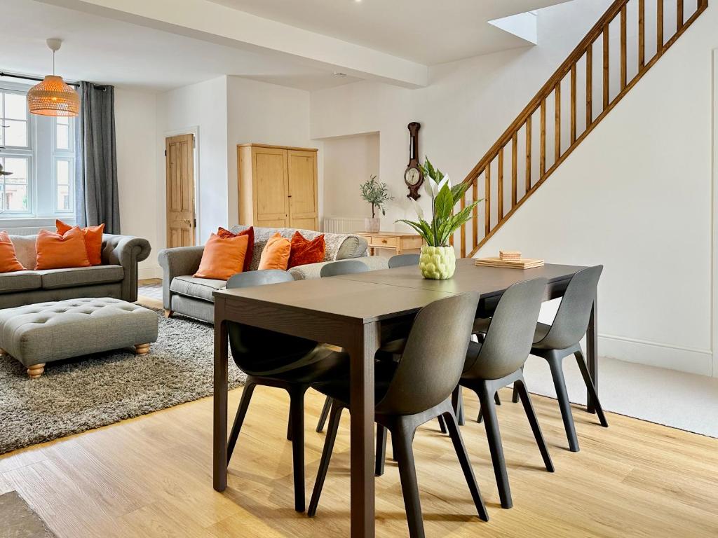 a dining room table and chairs in a living room at The Annex - central Helmsley with parking in Helmsley