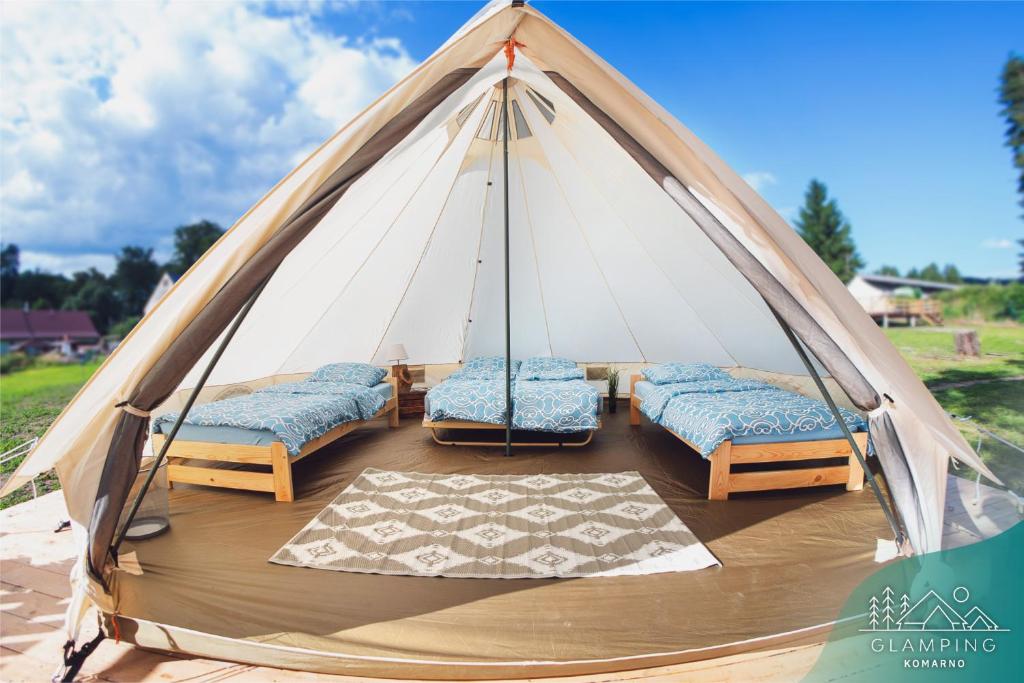 a group of beds in a teepee tent at Glamping Komarno in Jelenia Góra