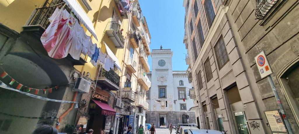 a city street with buildings and a clock tower at Il Fondaco all'Archivio Storico in Naples