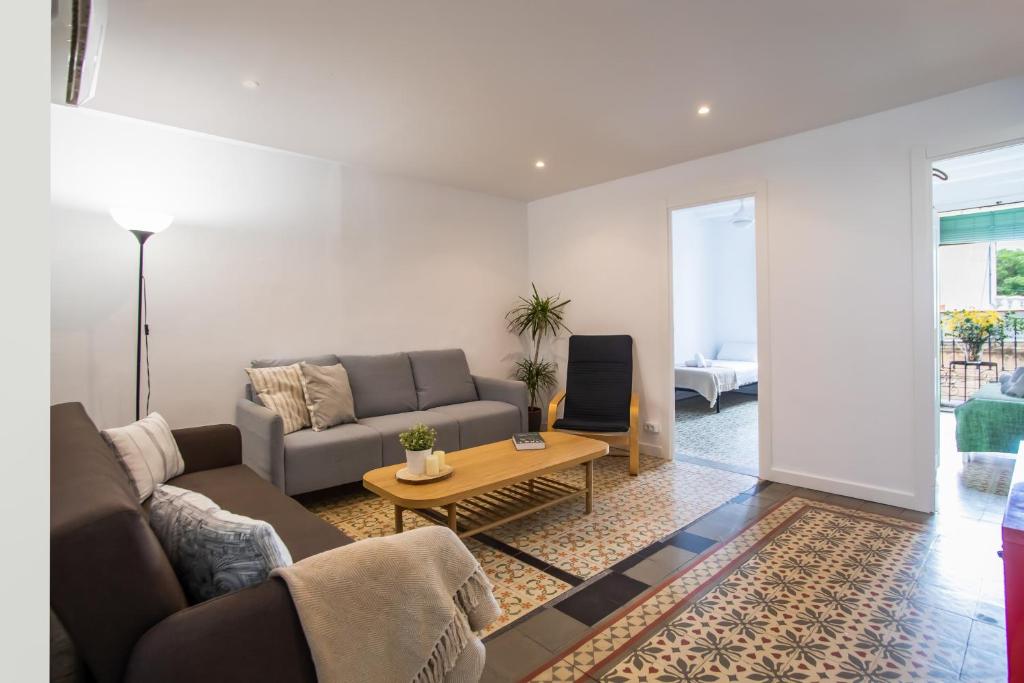 a living room with a couch and a table at BBarcelona Sants Flat in Barcelona