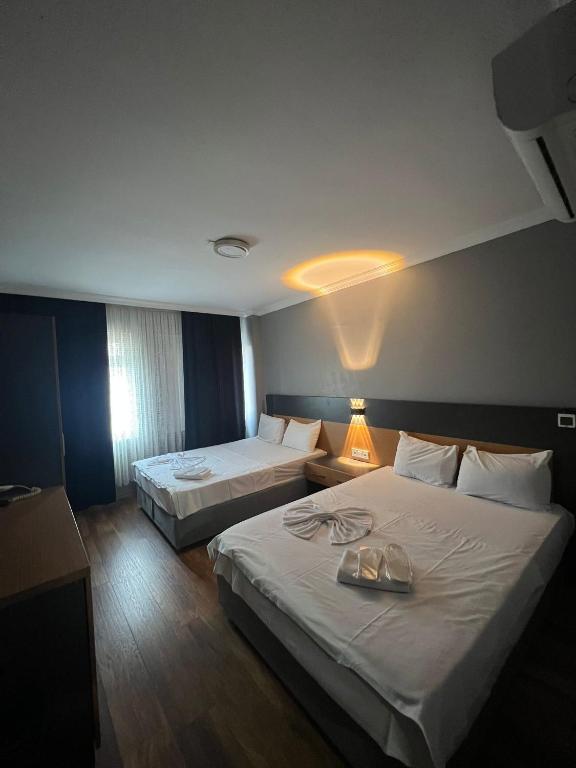 A bed or beds in a room at Hotel Otağ