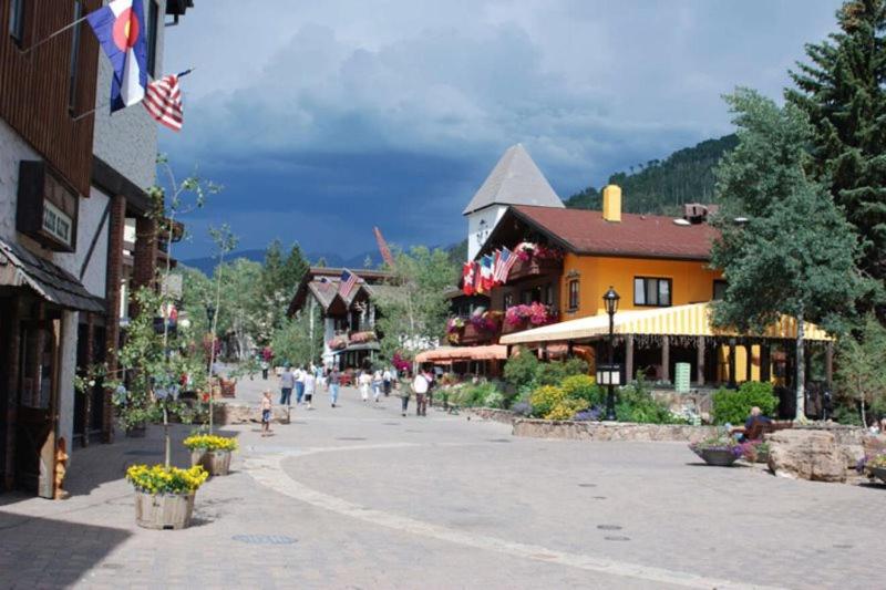 a street in a town with people walking down it at Vail Village Plaza Lodge 3 Bedroom Condo in Vail