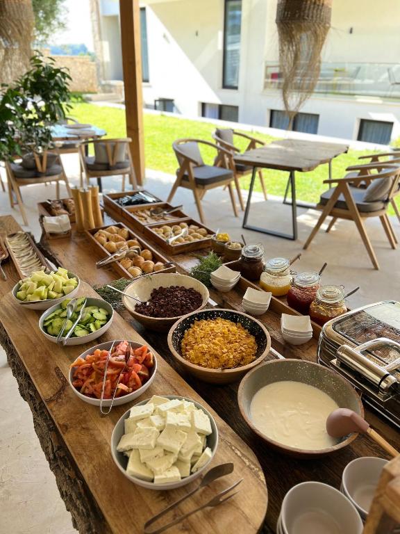 a table with many different dishes of food on it at Le Rêve Boutique Hotel in Dhërmi