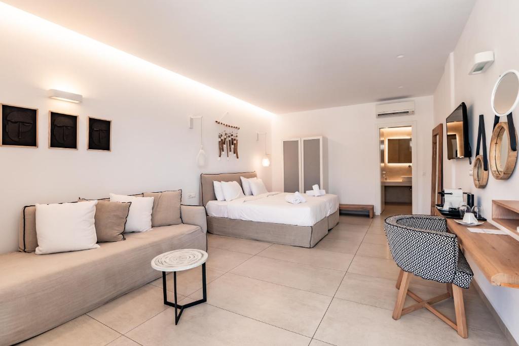 a living room with a couch and a bed at Super Paradise Hotel in Super Paradise Beach