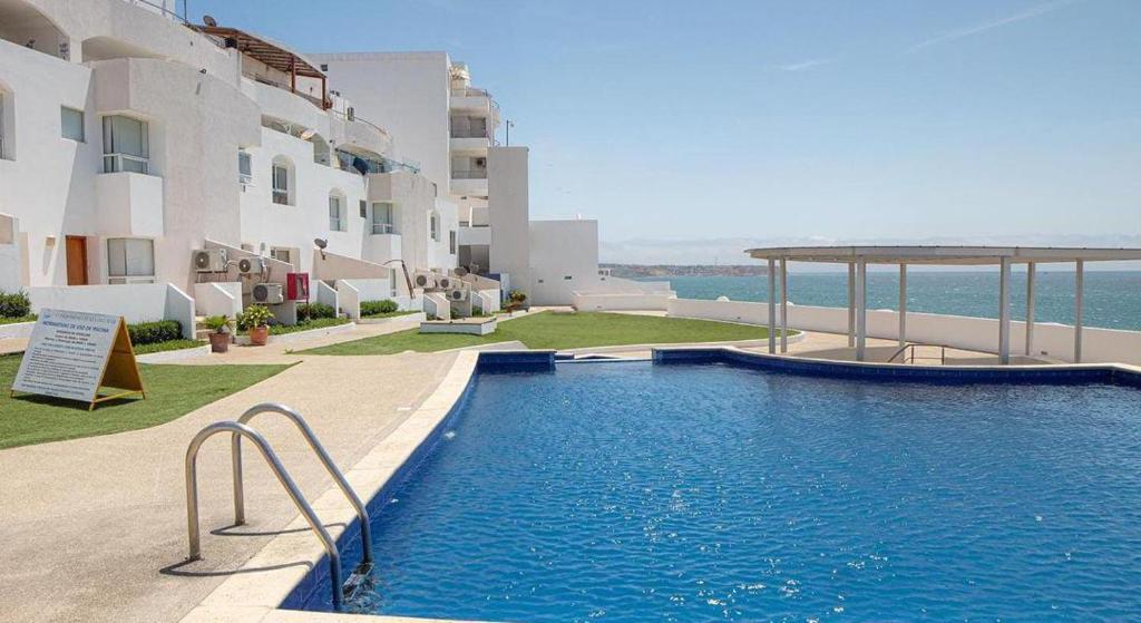 a large swimming pool in front of a building at Departamento amoblado Manta in Manta