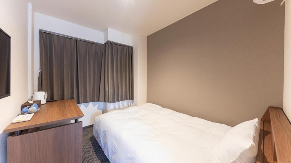 Rúm í herbergi á FLY CAT HOTEL