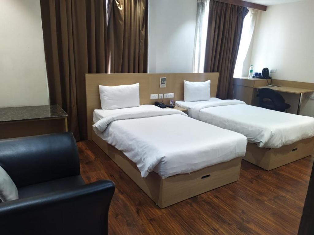 Postel nebo postele na pokoji v ubytování Hyphen Business Hotel