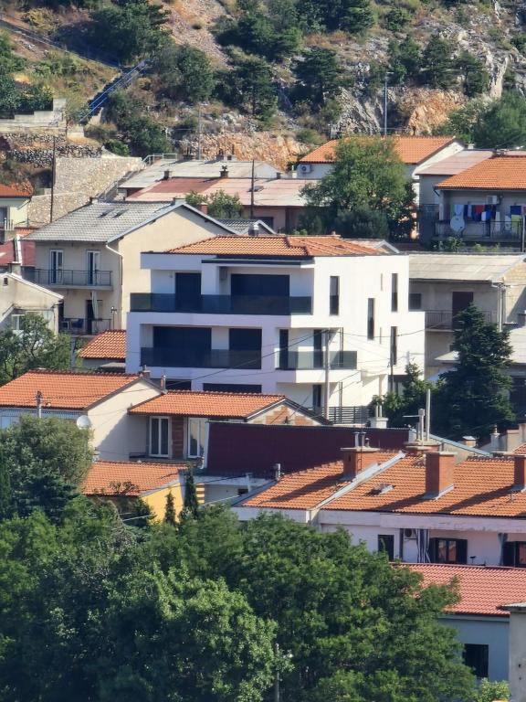 a group of buildings with red roofs at MA Apartments in Senj