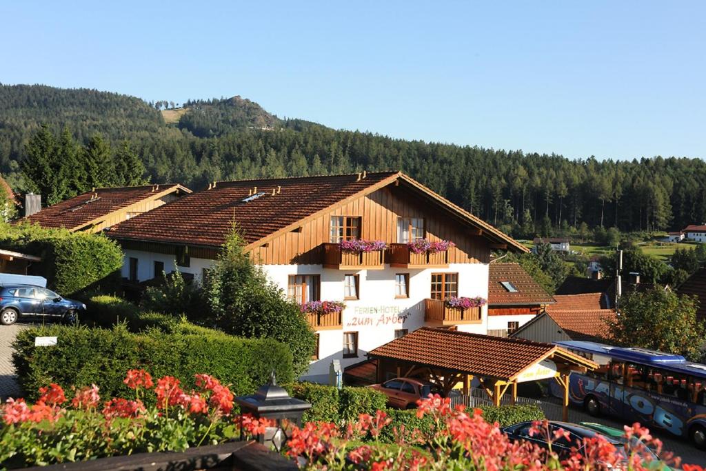 a building with a bus parked in a parking lot at Ferien- und Aktivhotel Zum Arber in Bodenmais