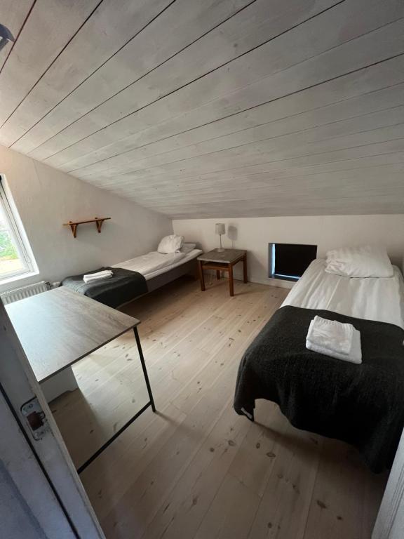 a bedroom with a bed and a couch and a tv at Visby City Apartments S:t Hansgatan in Visby