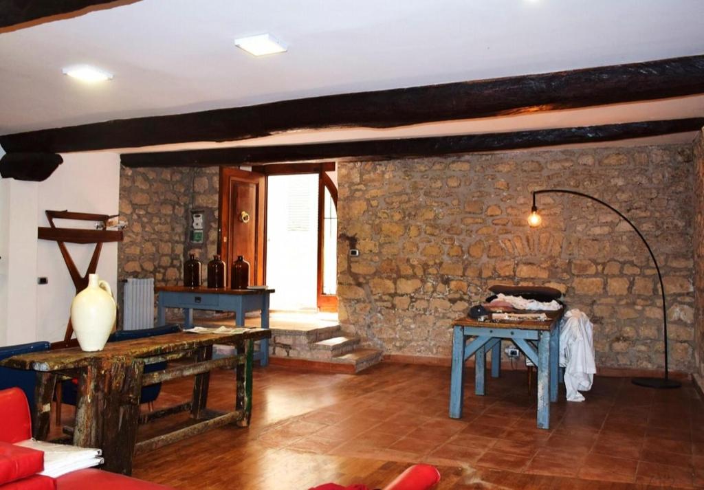 a living room with a stone wall and two tables at Casa di Piazza Castello in Fiuggi