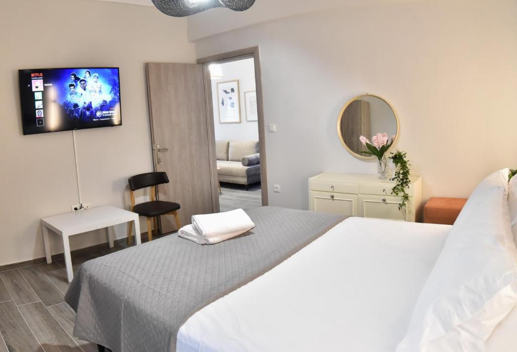 a bedroom with a bed and a tv on the wall at Comfort Spot 1 in Kavala