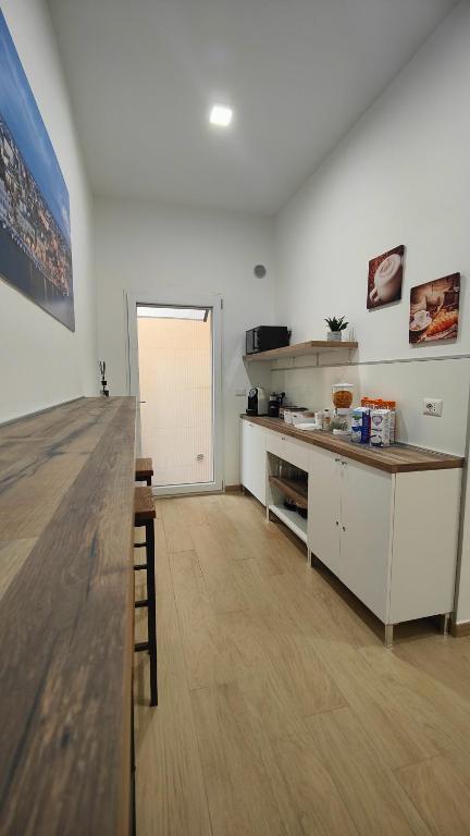 a kitchen with a counter and a table in a room at B&B IMMARE in Brindisi