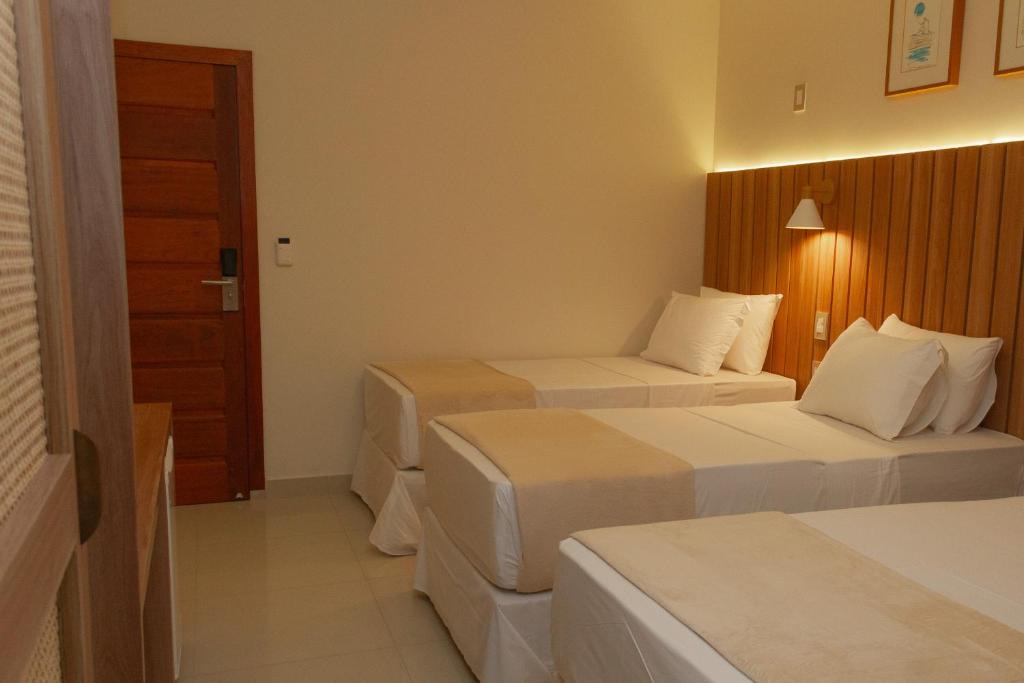 Postel nebo postele na pokoji v ubytování Principe do Mutá Hotel Design