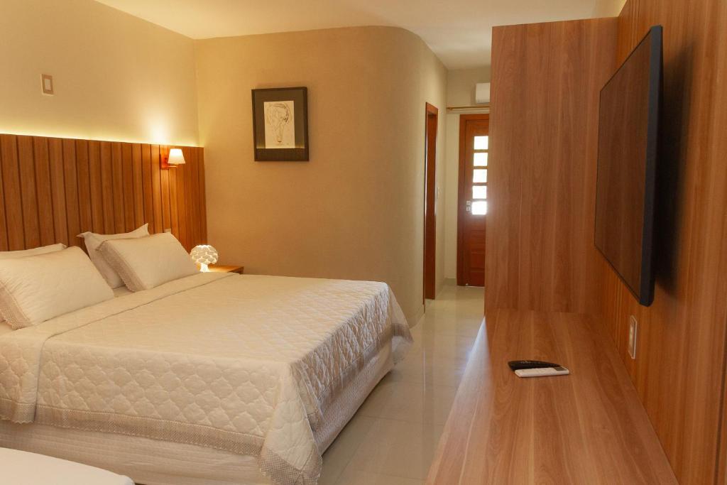 Postel nebo postele na pokoji v ubytování Principe do Mutá Hotel Design