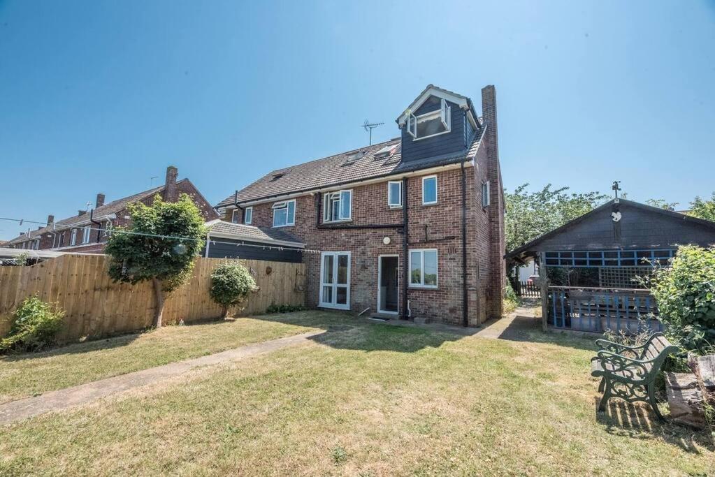 an old brick house with a fence in the yard at Number 27, Alderton in Woodbridge