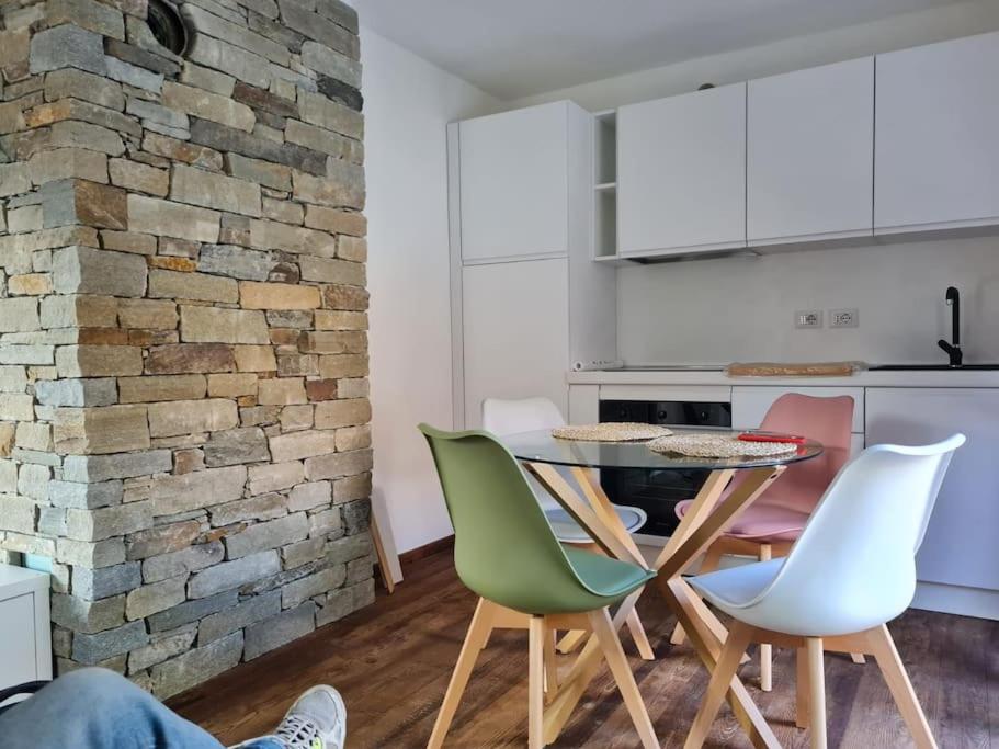 a kitchen and dining room with a table and chairs at ChaletMagnan in Lanzada