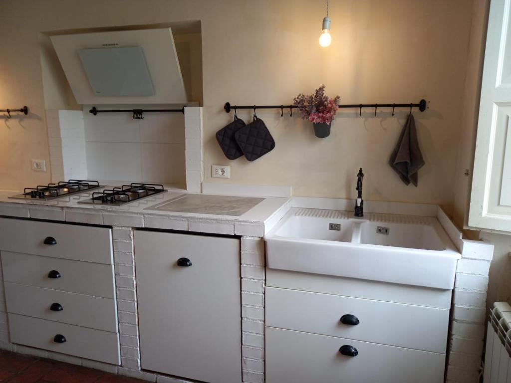 a kitchen with a sink and a stove at Casa Garibaldi in Lucca