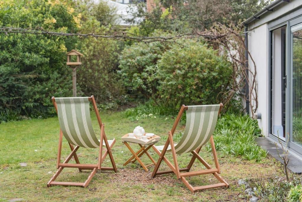 two chairs and a table in a yard at The Secret Garden in Kingsdown