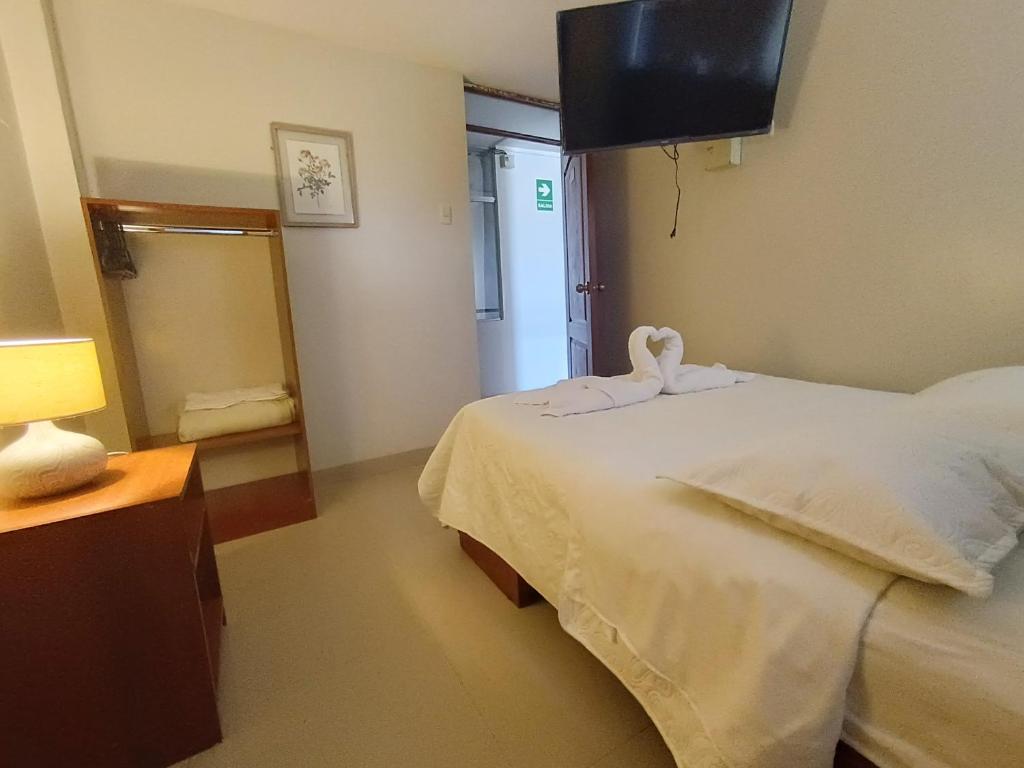 um quarto com uma cama com um cisne em hospedaje encantada em Cajamarca