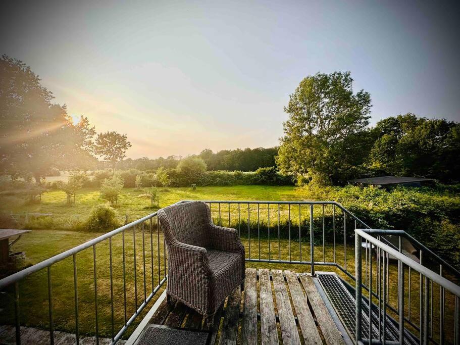 a chair sitting on a balcony with a view of a field at Grosses 2 Zi-DG in grüner Idylle! in Bliestorf