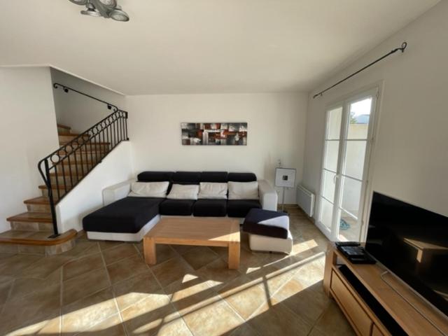 a bedroom with a bed and a table in a room at Résidence quai St Louis Villa t4 pour 6 personnes N1 47 in Aigues-Mortes