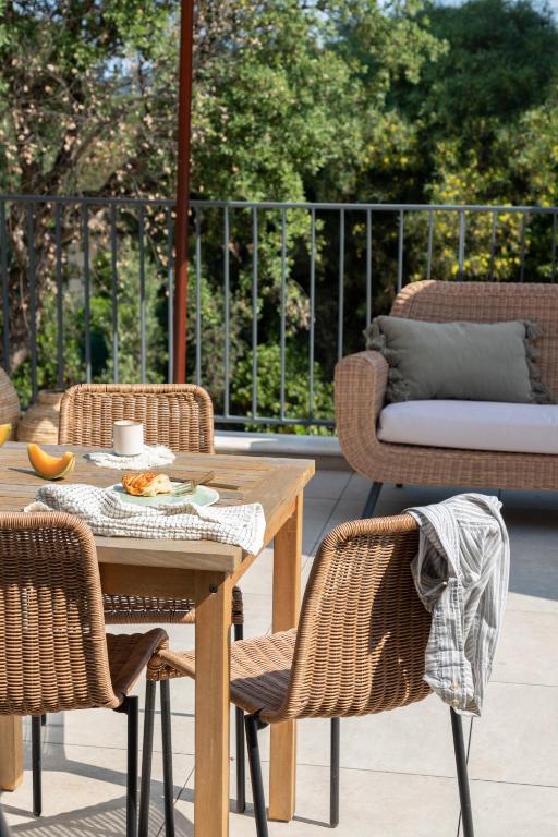 a patio with a table and chairs and a couch at Hôtel L'Escalet in Ramatuelle