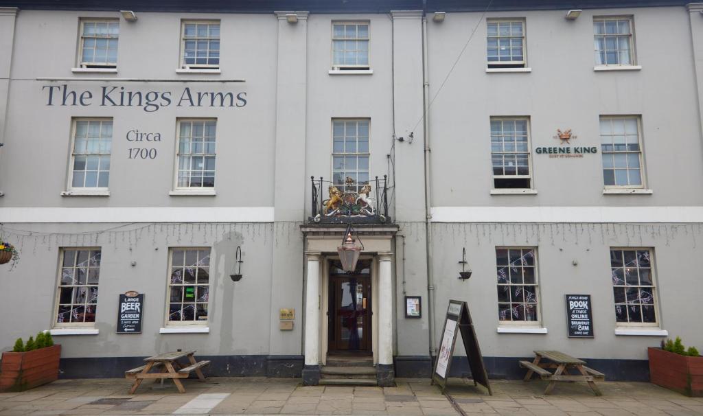a white building with a sign that reads the kings arms at Kings Arms Hotel by Greene King Inns in Westerham