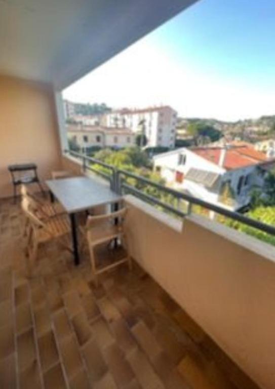 a room with a table and a large window at Studio with large balcony and nice view by Weekome in Vallauris