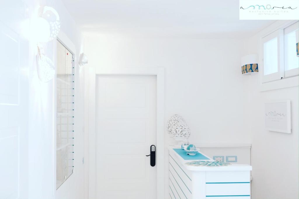 a bathroom with a blue sink and a white door at AMAREA Exclusive Suites in San Felice Circeo