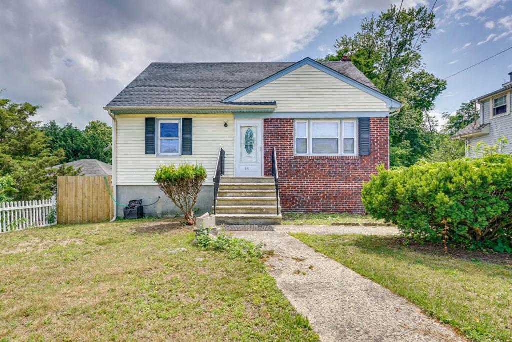 a white house with a brick at Middletown Township Home, Close to Beaches! in Leonardo