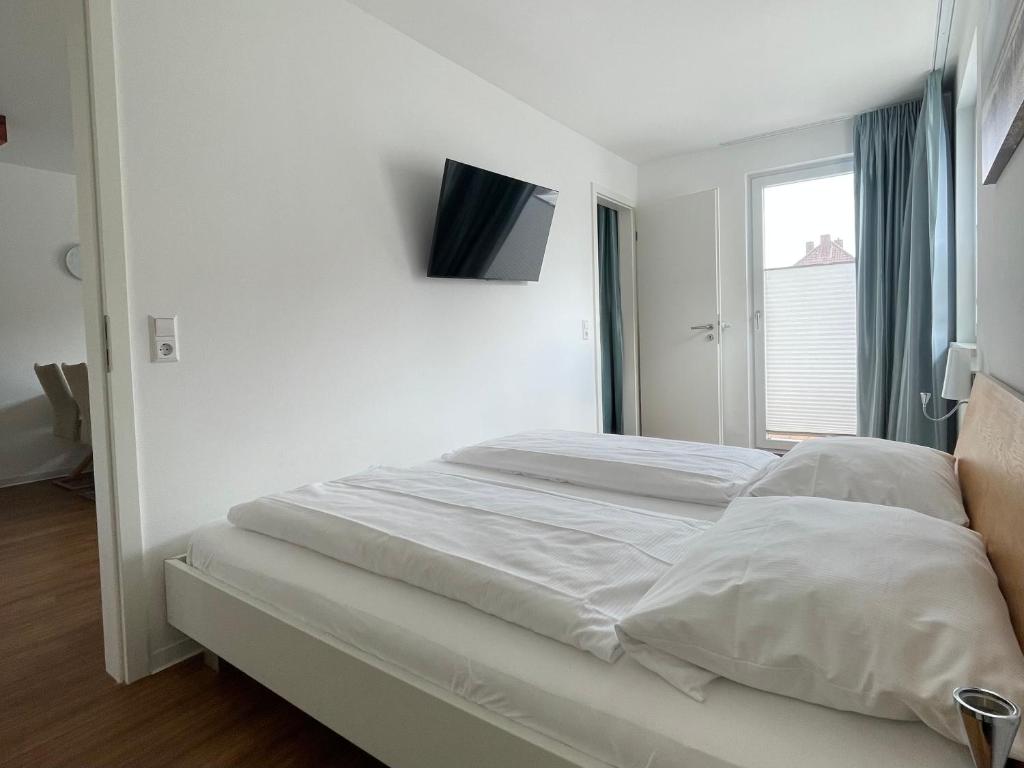 Voodi või voodid majutusasutuse Apartments Boardinghaus Norderney toas