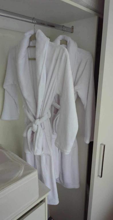 a group of white towels hanging on a rack at Glenelg resort style beachside apartment in Glenelg