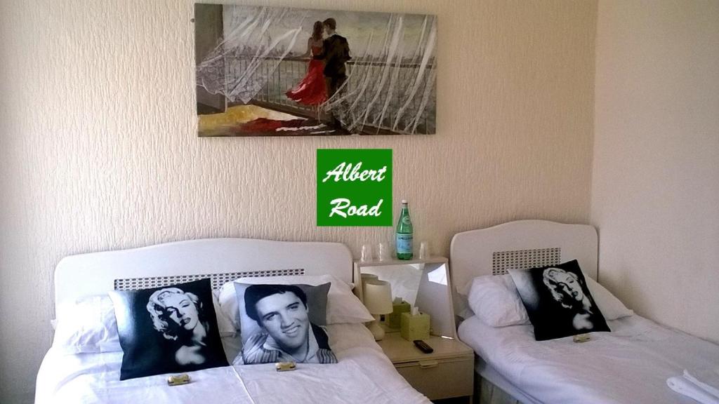 Habitación con 2 camas y una foto en la pared. en The Albert Hotel Near Winter Gardens, en Blackpool