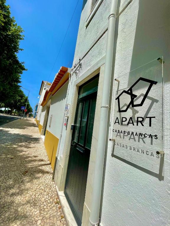 a sign on the side of a building with a door at APART Casas Brancas in Vila Viçosa