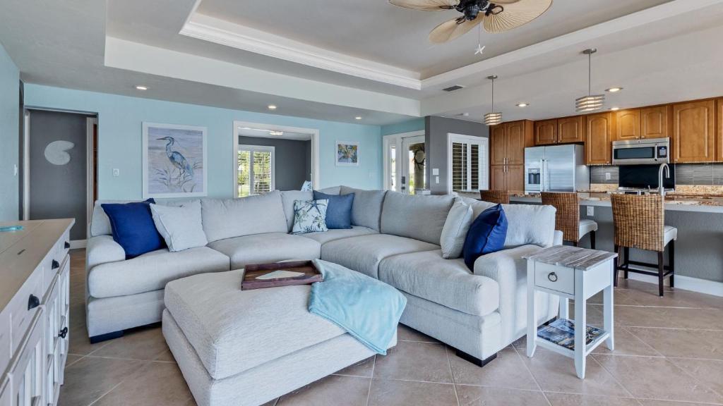 a living room with a couch and a kitchen at 829 Napoli in Punta Gorda