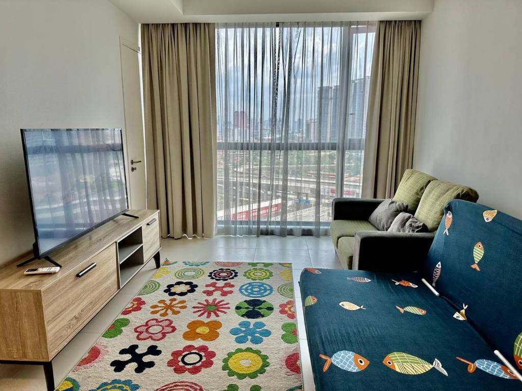 a living room with a flat screen tv and a couch at Luxury Condo Jalan Tun Razak in Kuala Lumpur