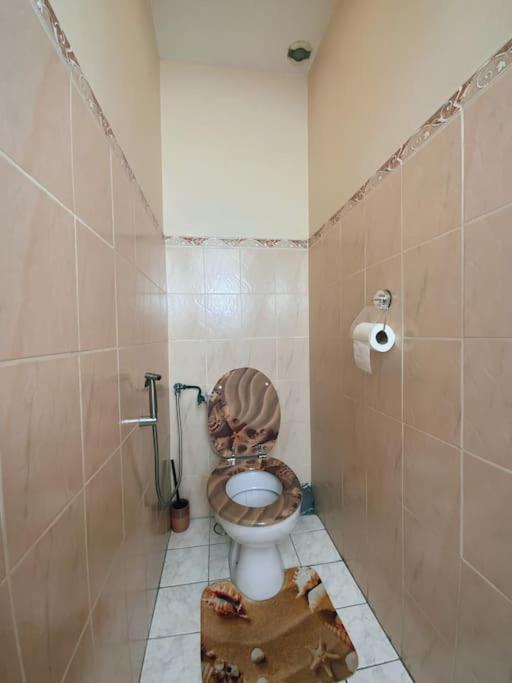 a bathroom with a dirty toilet in a stall at La Violette ONLY WOMEN femmes uniquement in Vénissieux