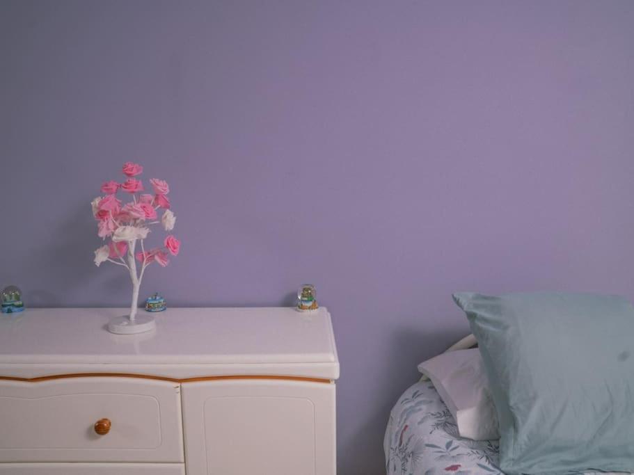 a bedroom with a white dresser and a purple wall at La Violette ONLY WOMEN femmes uniquement in Vénissieux