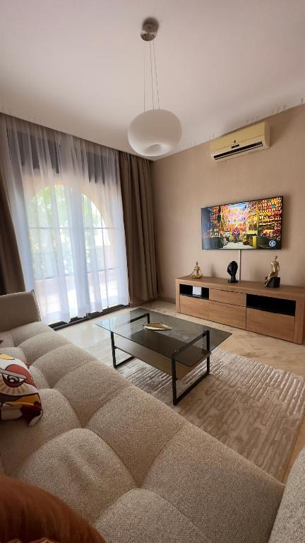 a living room with a couch and a glass table at Palm View in Marrakesh