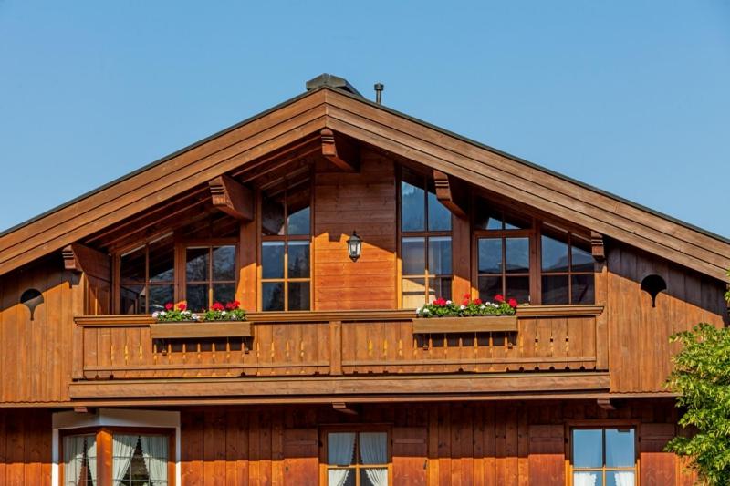 a large wooden house with a large balcony at Chalet Weißlofer in Reit im Winkl