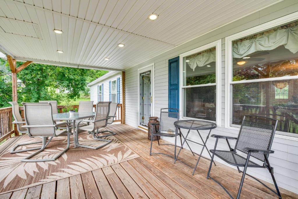 a screened in porch with a table and chairs at Charming Berwick Retreat with Gas Grill and Deck! in Berwick