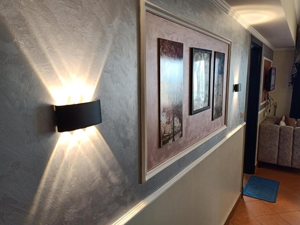 a room with a light on a wall with a picture at Porto Marina Rental in El Alamein