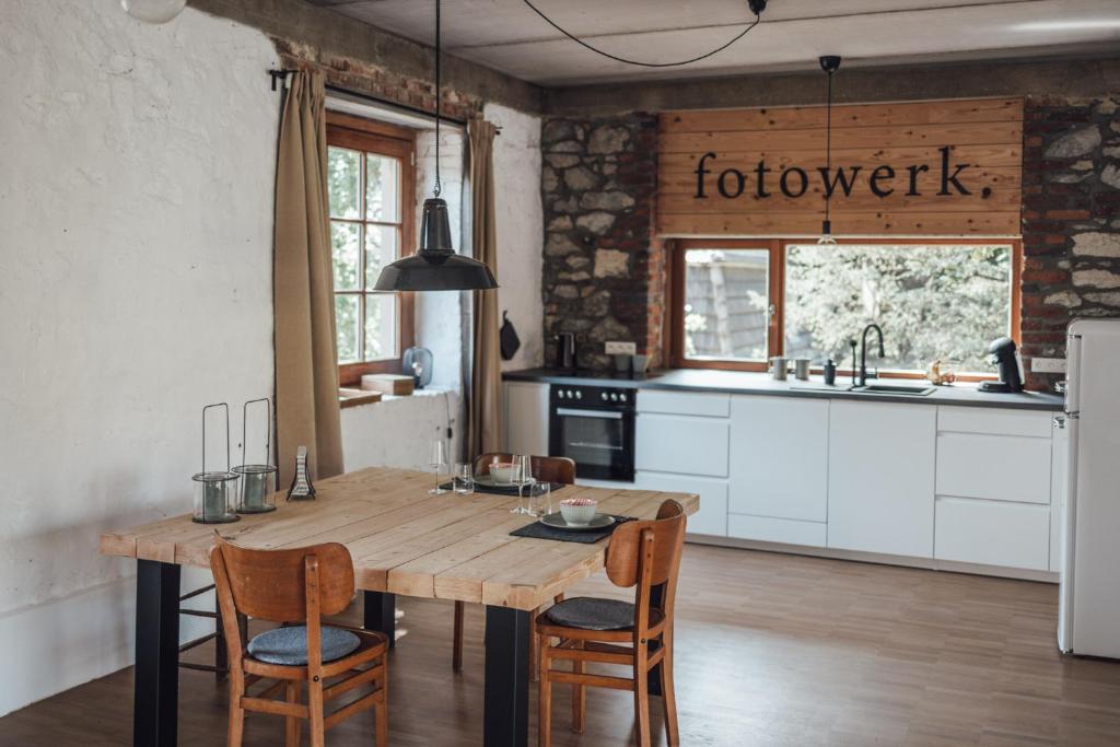 a kitchen with a wooden table and chairs at Loft 88 in Eupen