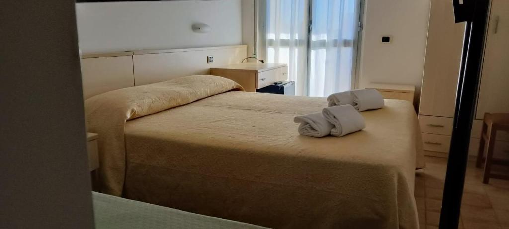 a bedroom with two beds with towels on it at Hotel Holiday in Giulianova
