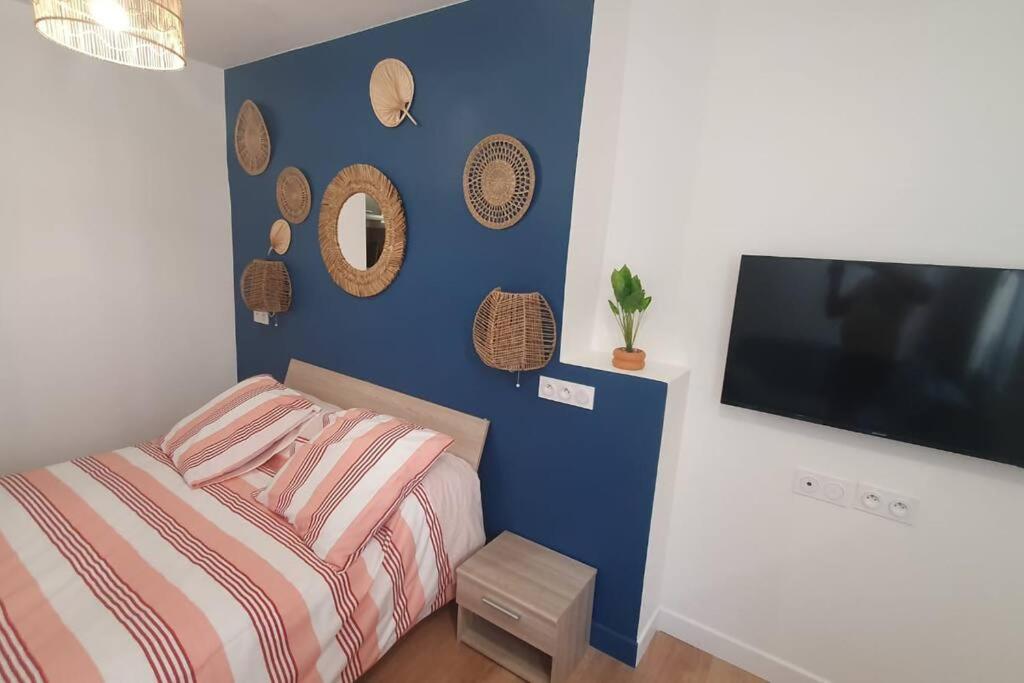 une chambre avec un lit et une télévision à écran plat dans l'établissement Studio palais de justice, à Rouen